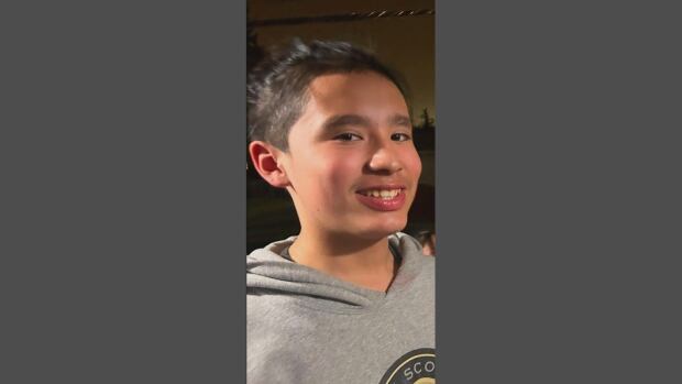 Eric Omeasoo, 13, died Wednesday after a suffering stab wound at a downtown LRT station in Edmonton. A smiling boy in a grey hoodie.