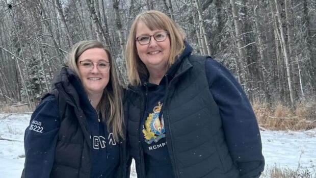 Family say RCMP civilian members Corinne Marybelle Fitzgerald, 49, and Meagan Carissa Briand, 33, were devoted to the kids Aliyah, 10, and Brody, 8 two women smiling outside against a snowy treelined backdrop