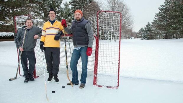 RinkWatch founders Haydn Lawrence, Robert McLeman, and Colin Robertson. Three people standing on an outdoor rink with hockey sticks.