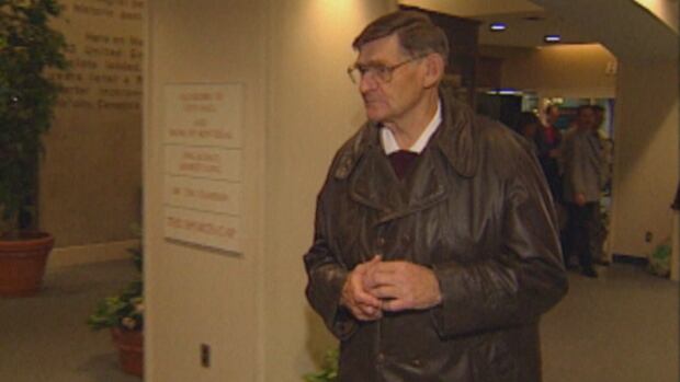 In this file photo, former police sergeant Kenneth Estabrooks leaves a court appearance in provincial court after he was charged with indecently assaulting several children while he was a police officer. He was found guilty in 1999 on four of the charges. Man in brown leather jacket.