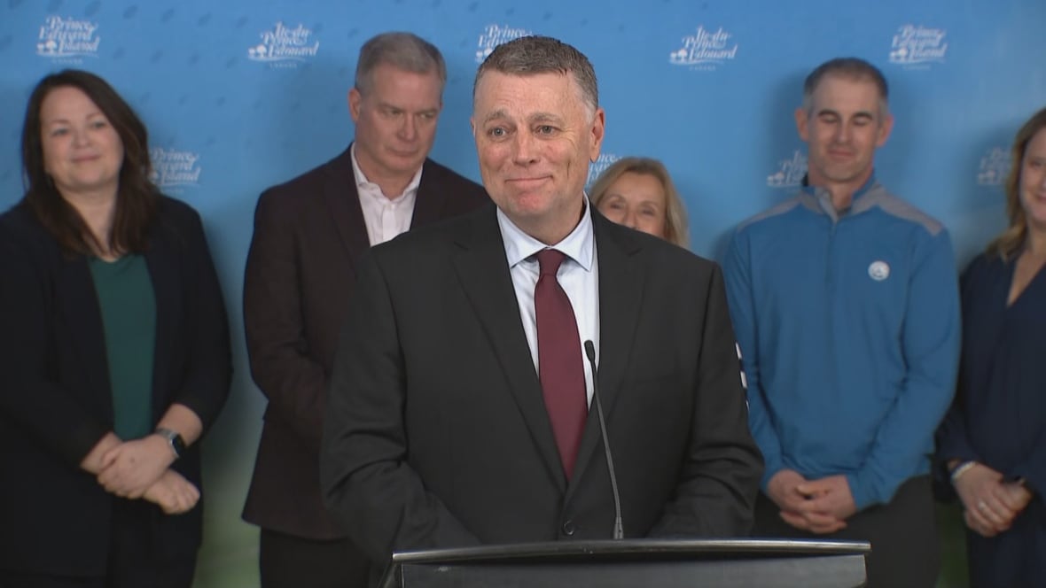 Dennis King stands at a podium