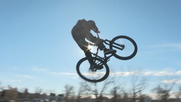 The Jump and Bike Skills Association of Calgary is calling on the city to build public dirt jumps to serve the growing biking community. A bike rider makes a jump off a ramp.