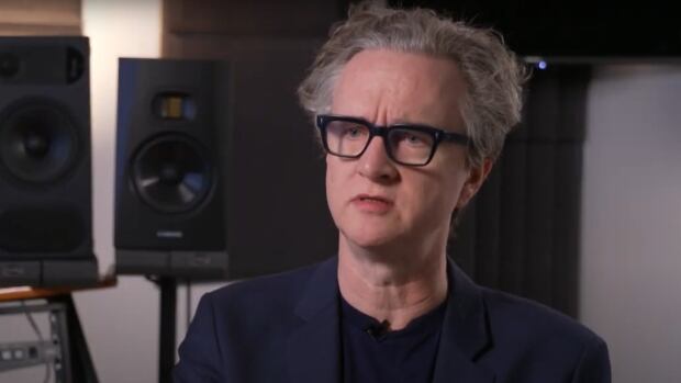 Greg Wells is a music producer based in Los Angeles. A man sitting in a recording studio.