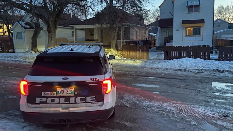 A police car parked on a snowy street