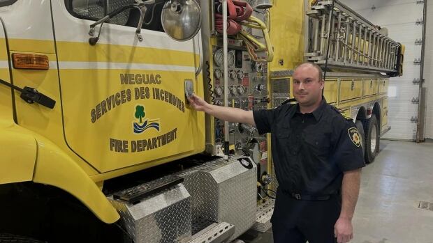 Neguac Deputy Fire Chief Bernard Comeau was one of two firefighters who recently helped a woman give birth when an ambulance wasn't available. A firefighter poses in front of a fire truck