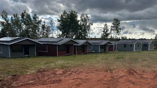 Cottages that used to be rented out as part of the Royalty Maples Motel and Cottages operation on Malpeque Road were moved in October 2024 to a field off Sleepy Hollow Road. Seven brown and green cottages with solar panels on their roofs sit in a brown muddy field.