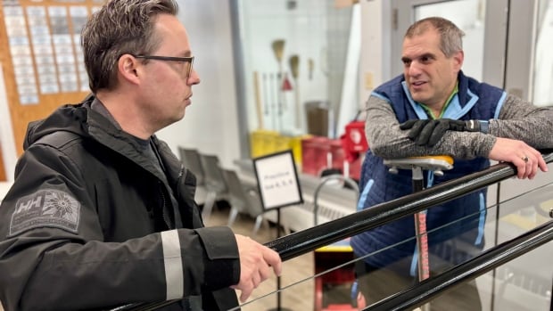 Summerside Mayor Dan Kutcher chats with Ken Robichaud at the Silver Fox on Wednesday. A man with glasses in a black windbreaker talks to a man in a grey sweater and blue vest.