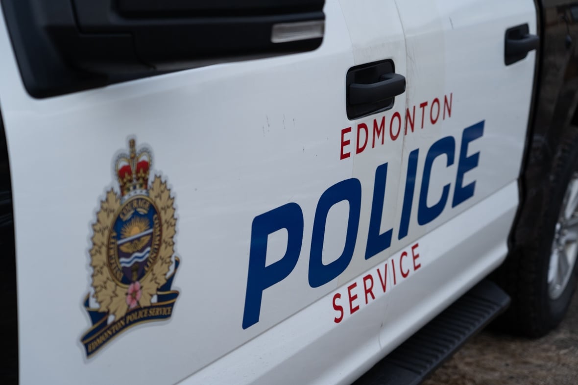 A white vehicle with "Edmonton Police Service" and a police emblem on the side.