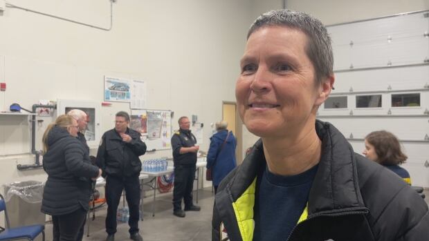 Debbie MacInnis, a volunteer firefighter with the Charlottetown Fire Department, at a female first responders networking event on March 7, 2025. A woman wearing a casual firefighters uniform standing in a fire school. She is not looking at the camera.