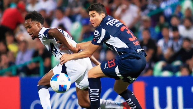 Two men fight for a soccer ball 