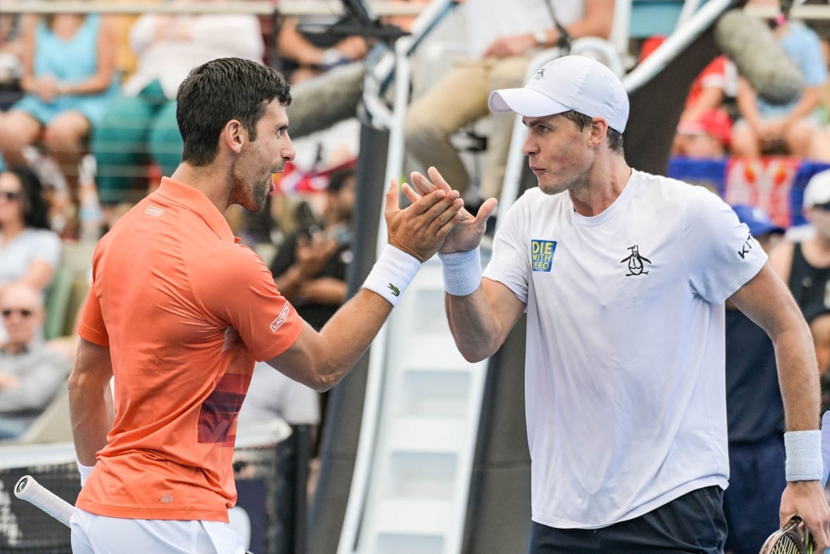 Two tennis players celebrate.