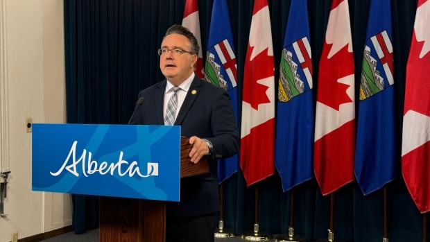 A man stands behind a podium.