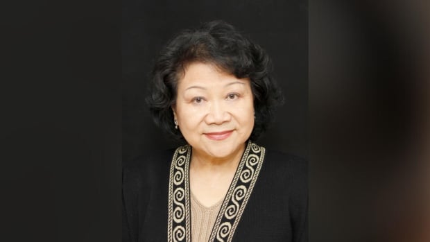 An East Asian woman wearing black smiles in a headshot.
