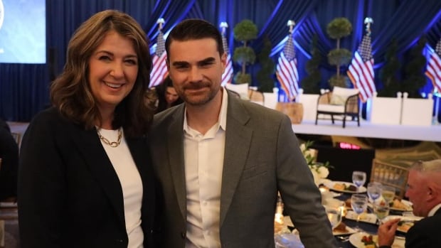Alberta Premier Danielle Smith poses with U.S. conservative podcaster Ben Shapiro at the fundraising gala they co-headlined in Florida last week. CBC News has obtained a video of their onstage discussion. two people smiling into the camera