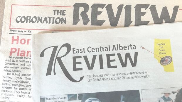 A photo of two newspapers stacked asymmetrically. The top newspaper is titled "East Central Alberta Review."
