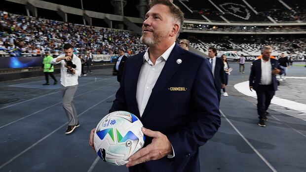 CONMEBOL president Alejandro Dominguez approaches the stands to gift a ball to fans prior to the Recopa Sudamericana second leg match between Botafogo and Racing Club at Estadio Olímpico Nilton Santos on February 27, 2025 in Rio de Janeiro, Brazil. 