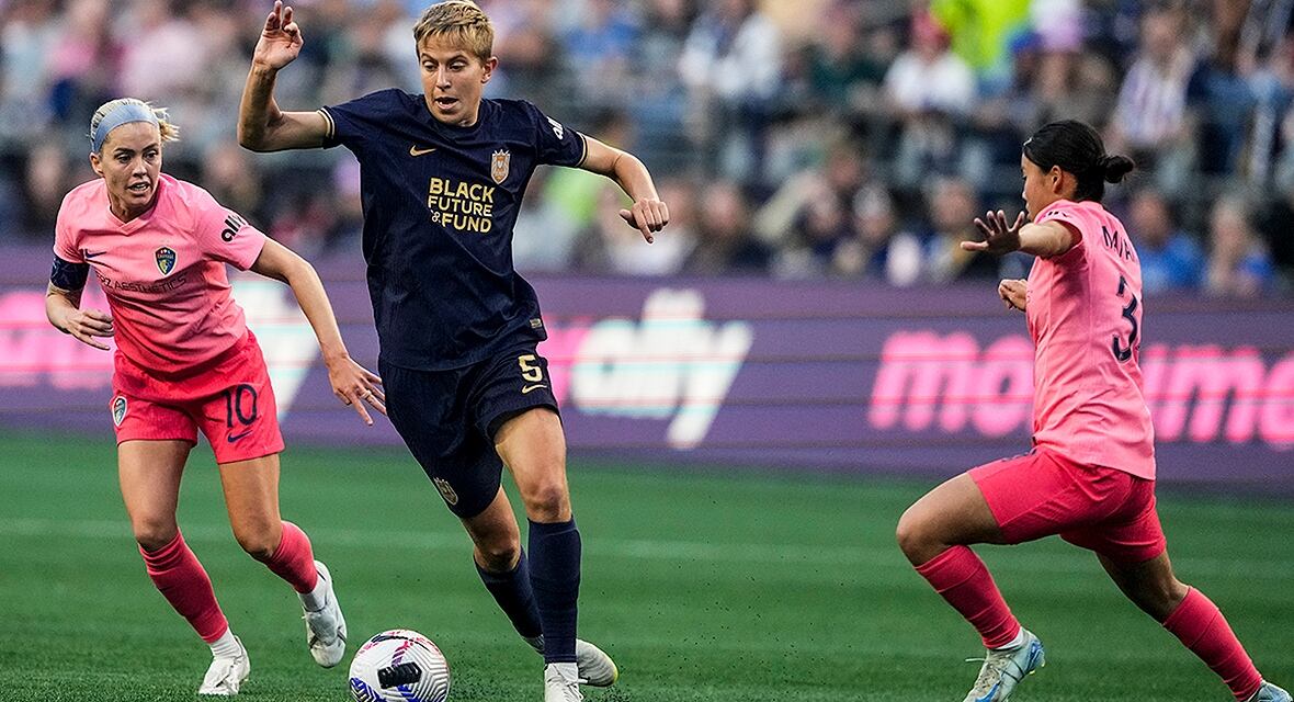 Seattle Reign midfielder Quinn moves the ball against a North Carolina Courage opponent during the first half of an August 25, 2024, National Women’s Soccer League match. 