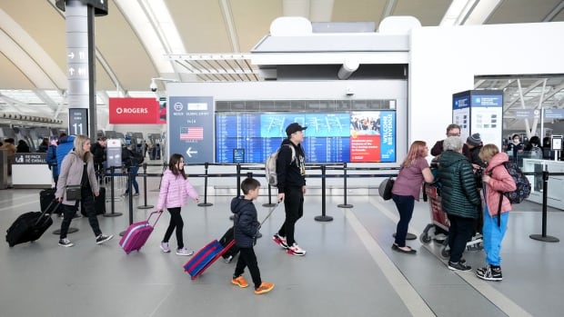People are shown at Pearson International Airport in Toronto on Friday, March 10, 2023. 