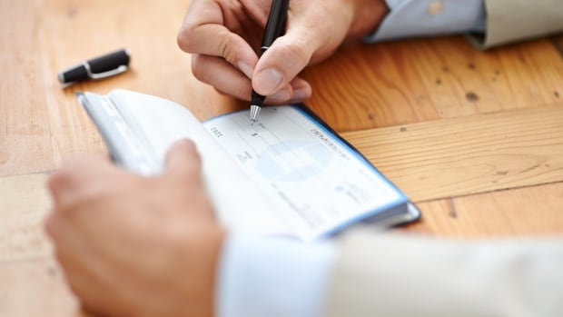 Hands, businessman sign cheque or accountant closeup and signature for consent or confirmation.