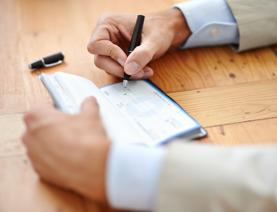 Hands, businessman sign cheque or accountant closeup and signature for consent or confirmation.