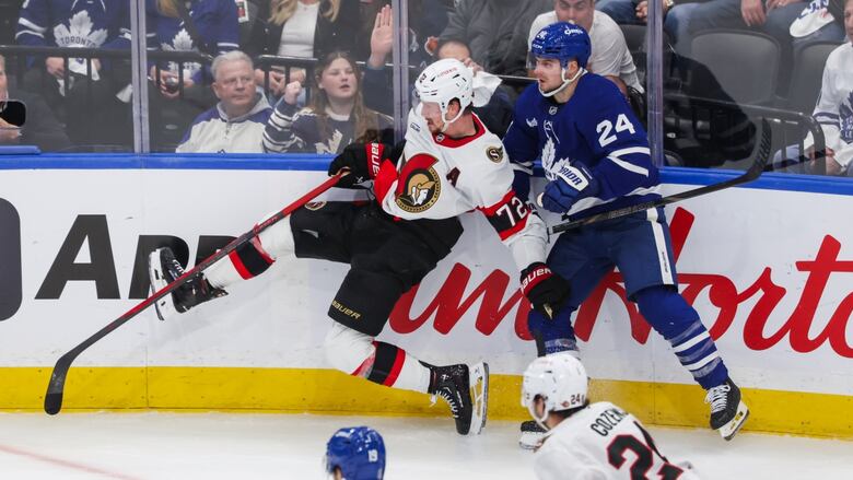 Toronto Maple Leafs' Scott Laughton (24) and Ottawa Senators' Thomas Chabot (72) collide on  the boards during 2nd  play  NHL playoff enactment   successful  Toronto connected  Tuesday, April 22, 2025. THE CANADIAN PRESS/Nick Iwanyshyn