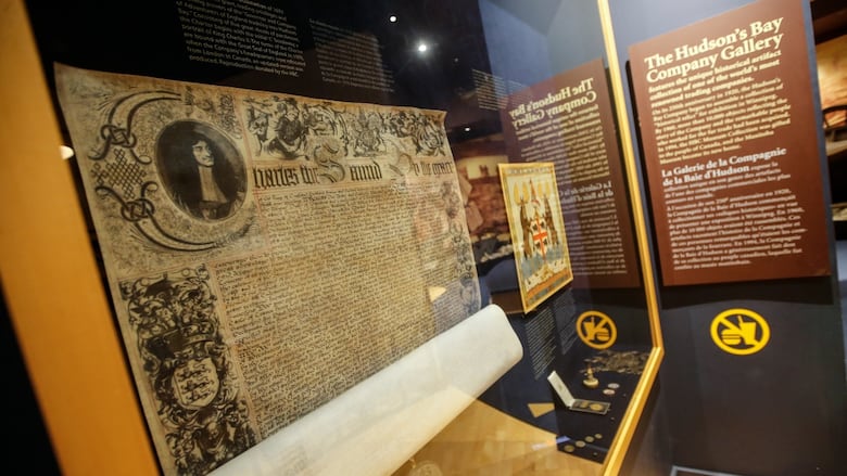 Artifacts are displayed in glass cases