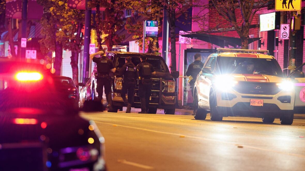 Police officers connected  a acheronian  street.