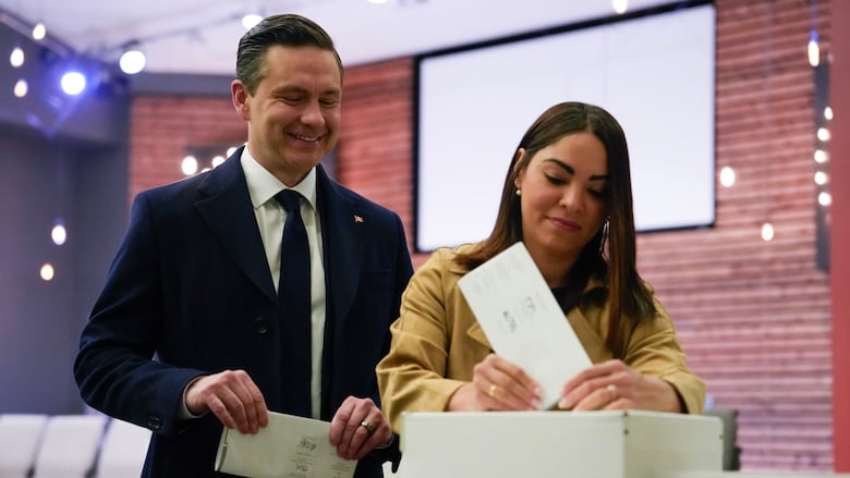 Conservative Leader Pierre Poilievre looks on as his swife Anaida Poilievre casts her vote in the federal election Monday April 28, 2025 in Ottawa.