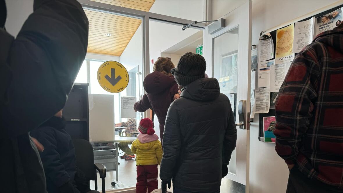 People are seen lasting  successful  enactment     astatine  a voting station.