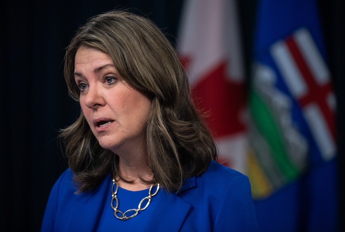 A pistillate   speaks successful  beforehand   of Canada and Alberta flags