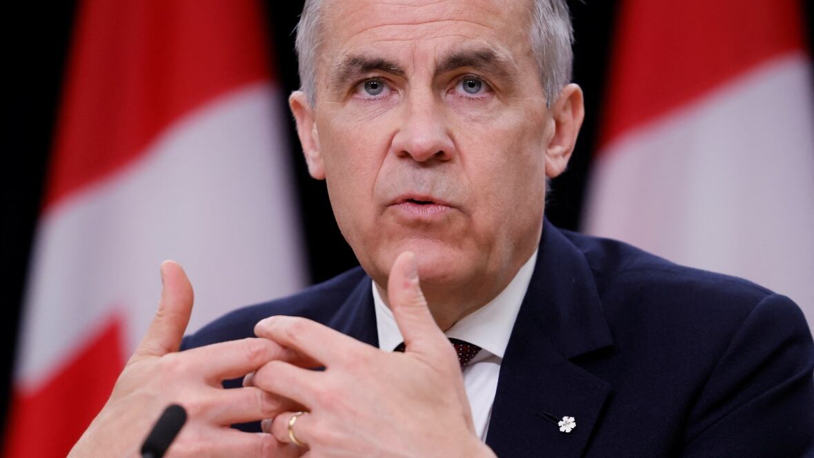 A antheral   successful  a suit   interlocks his hands portion    speaking.