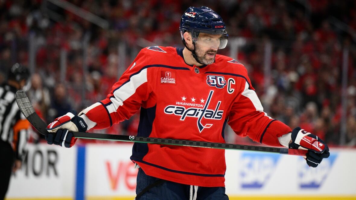 A hockey player holds his stick.