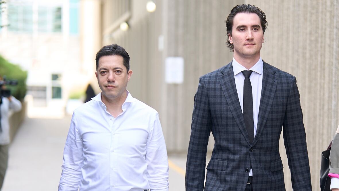 Two men walk out of a courthouse.