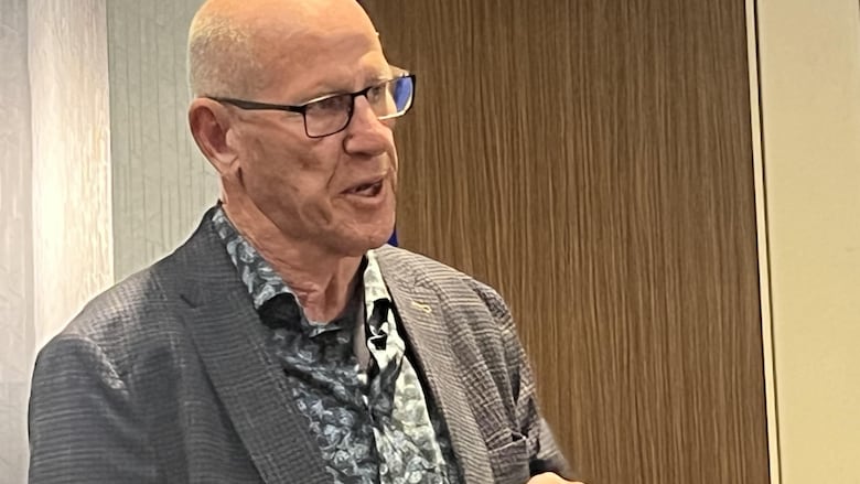 A man gestures as he speaks