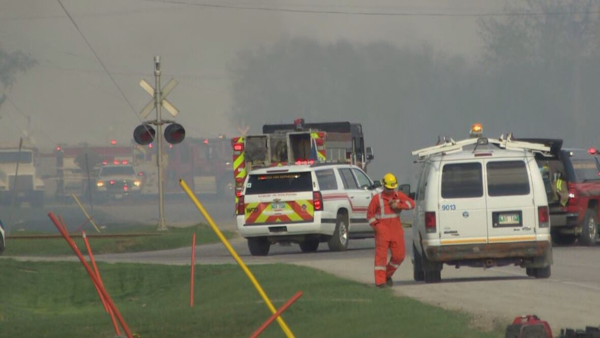 Multiple occurrence  trucks are parked connected  roadworthy  successful  effect   to a writer  fire.
