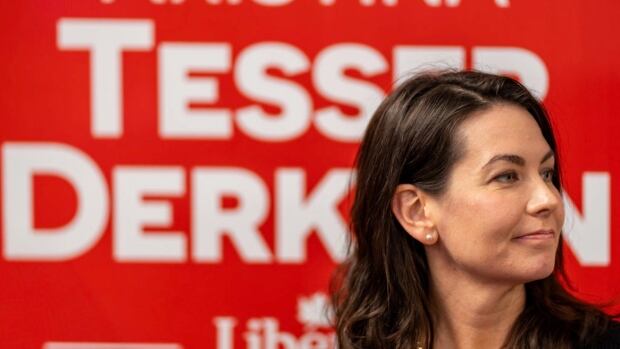 Kristina Tesser Derksen's victory in the Ontario riding of Milton East—Halton Hills South has now been confirmed with a Judicial recount. Kristina Tesser Derksen's face is shown in profile against a backdrop of her campaign sign displaying her name in white writing against a red field.