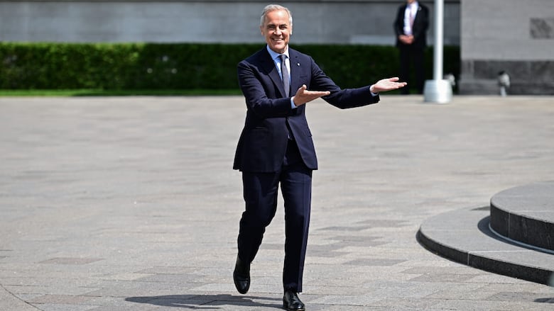 Man makes a gesture to his left while walking.