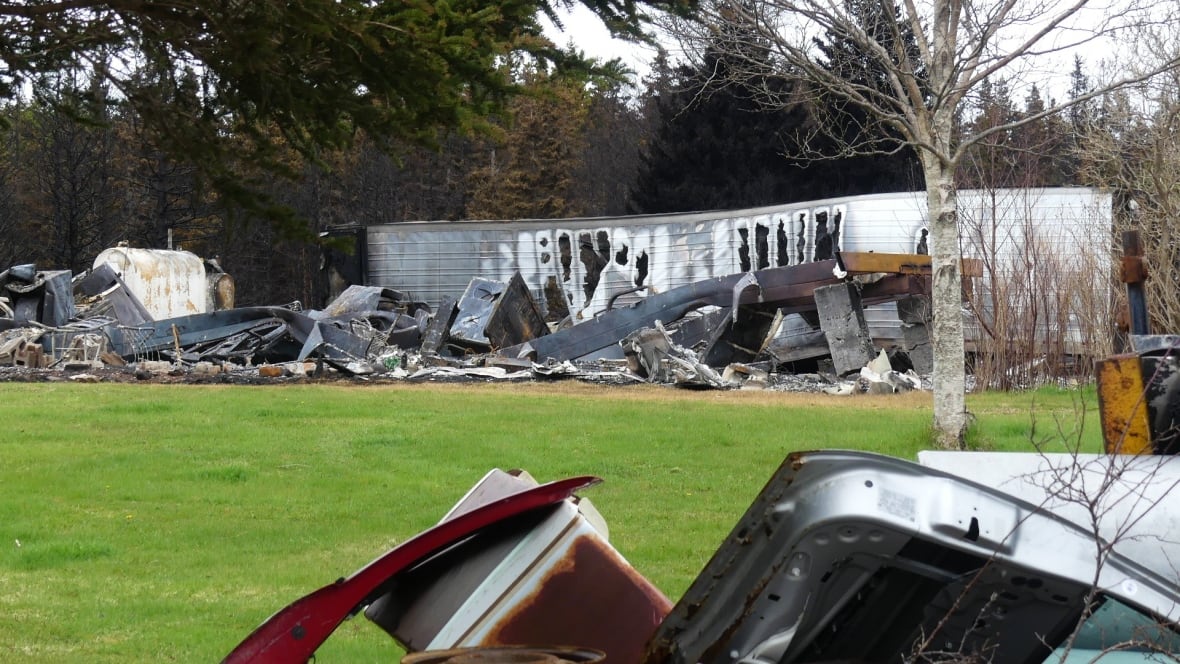 Burnt debris and large burnt truck trailer