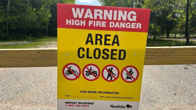a yellow, reddish  and achromatic  motion   reads "warning precocious   occurrence  danger" and "area closed"