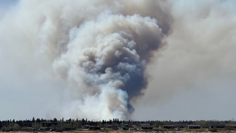 A plume of fume  billows to the sky. 