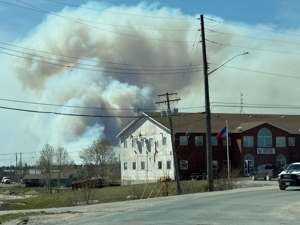 A plume of fume  billows from down  a gathering  successful  Pimicikamak Cree Nation.