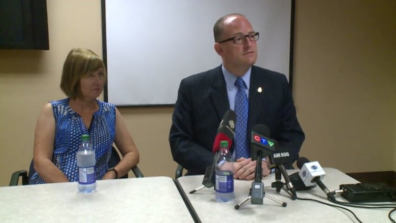 The mayor's wife and the mayor at a news conference.