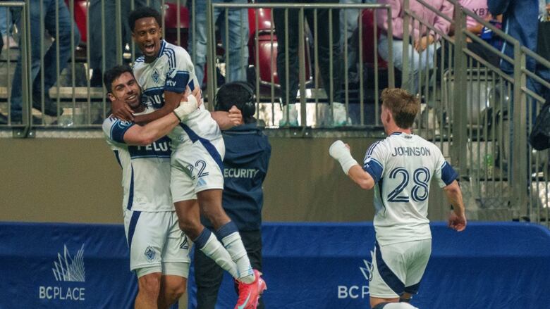 Vancouver Whitecaps' Brian White (left) celebrates his goal against Inter Miami with Ali Ahmed and Tate Johnson during the first half of a CONCACAF Champions Cup semifinal soccer match, in Vancouver, on Thursday, April 24, 2025.