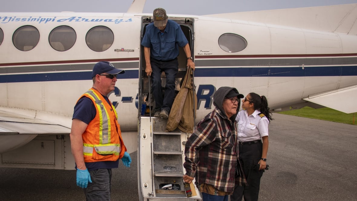 People getting off a plane