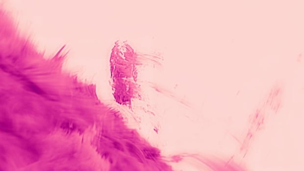 A pink fuzzy surface crosses the bottom of the frame, with a wispy blob shooting up into center frame.