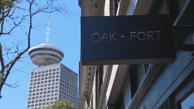 A sign reads'Oak + Fort' next to a tall tower.