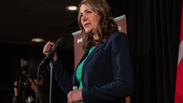 Alberta premier on stage talking to crowd