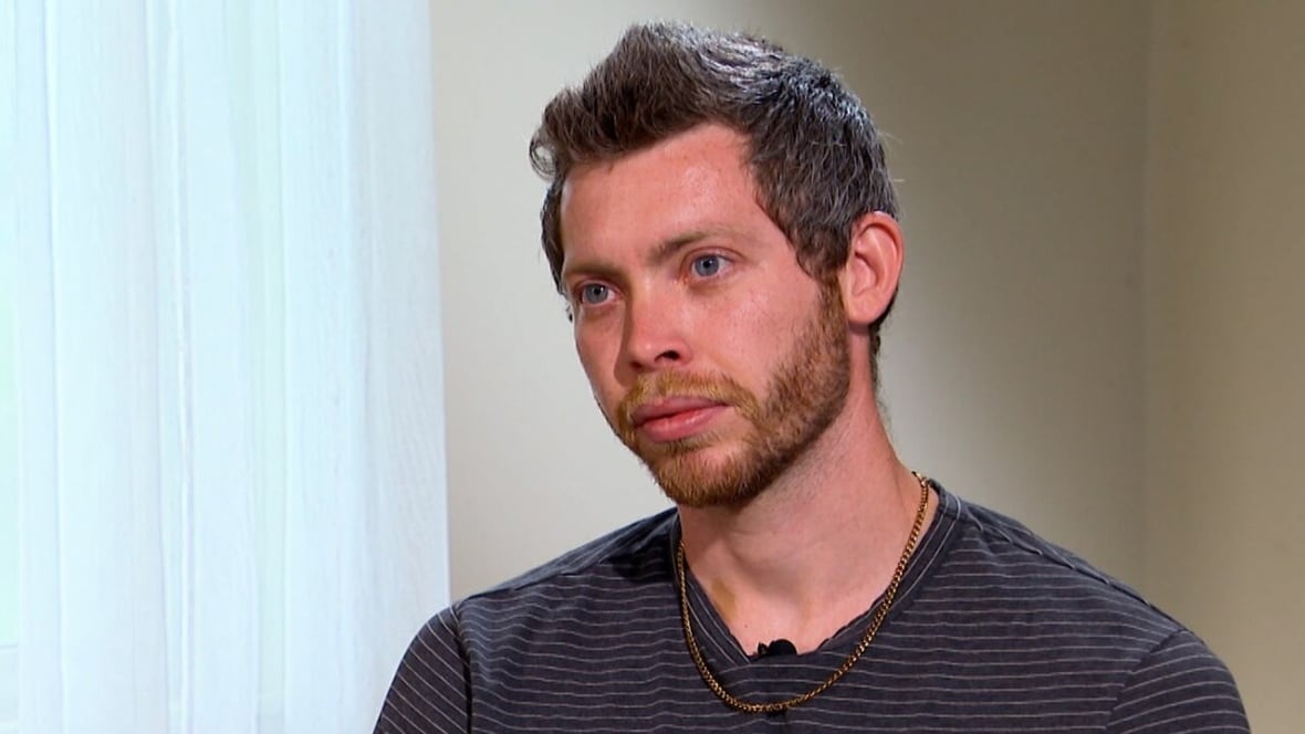 A man with a beard sits for an interview.