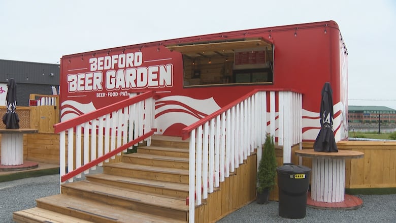 A large container labelled Bedford Beer Garden with a set of wooden stairs leading to an open serving window.