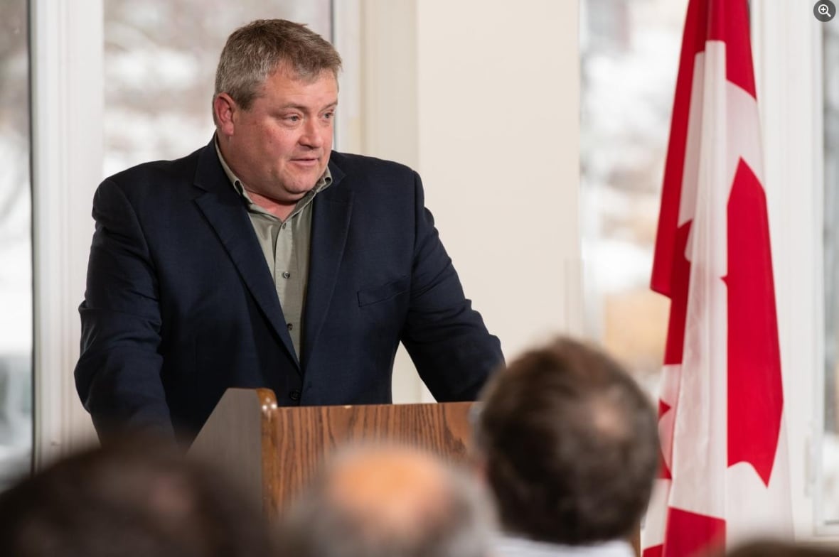A man stands at a podium